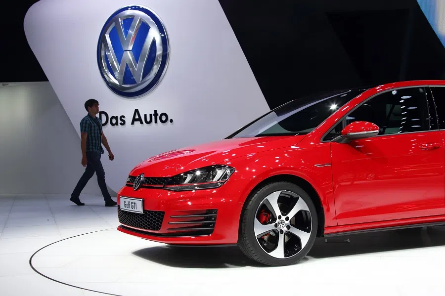 A man walks near a Volkswagen AG Golf GTI vehicle at the 16th Shanghai International Automobile Industry Exhibition (Auto Shanghai 2015) in Shanghai, China, on 20 April 2015. (Tomohiro Ohsumi/Bloomberg)