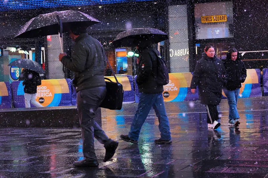 People walk along Times Square on 13 February 2024 in New York City, US. (Michael M. Santiago/Getty Images/AFP)