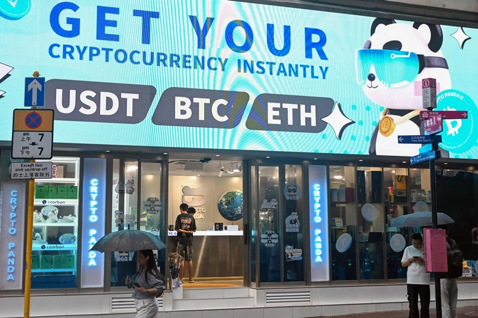 Bitcoin, ethereum and the stablecoin USDT are promoted at a cryptocurrency store in Hong Kong on 29 July 2025. (Peter Parks/AFP)
