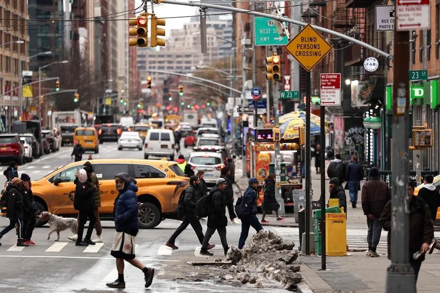People cross Manhattan's 7th Avenue in New York City, on 19 February 2026. (Charly Triballeau/AFP)