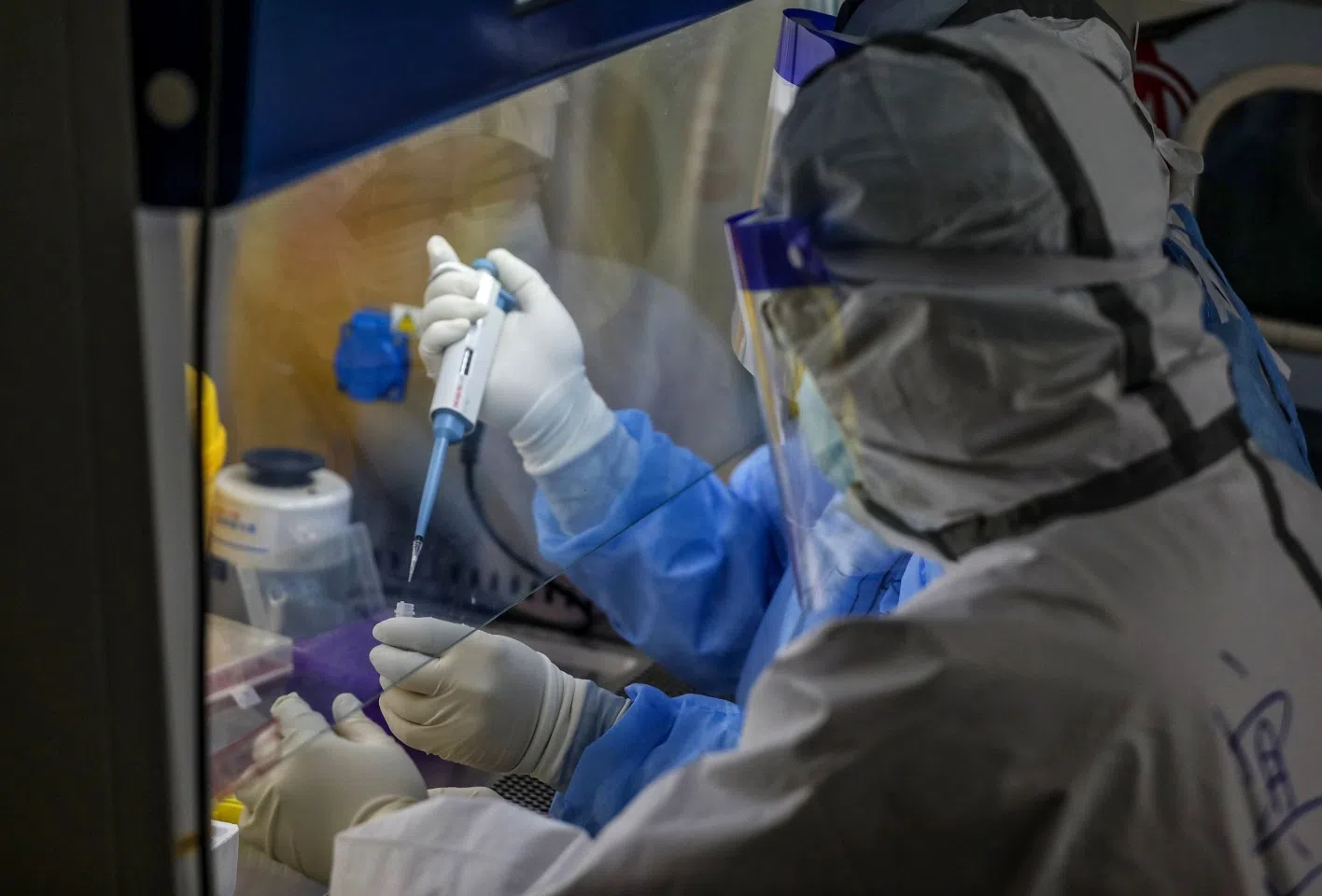 A medical staff member prepares nucleic acid tests for patients infected by the Covid-19 coronavirus at Red Cross Hospital in Wuhan, on 10 March 2020. (STR/AFP)