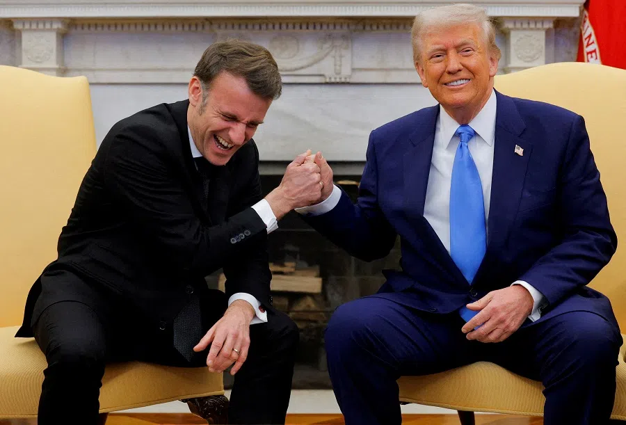 US President Donald Trump and French President Emmanuel Macron react during their meeting at the White House in Washington, DC, US, on 24 February 2025.