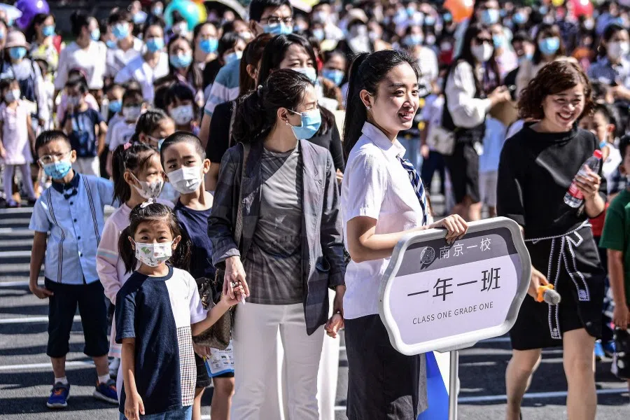First-year pupils arrive at a primary school for the new semester in Shenyang in China's northeastern Liaoning province on 30 August 2021. (STR/AFP)