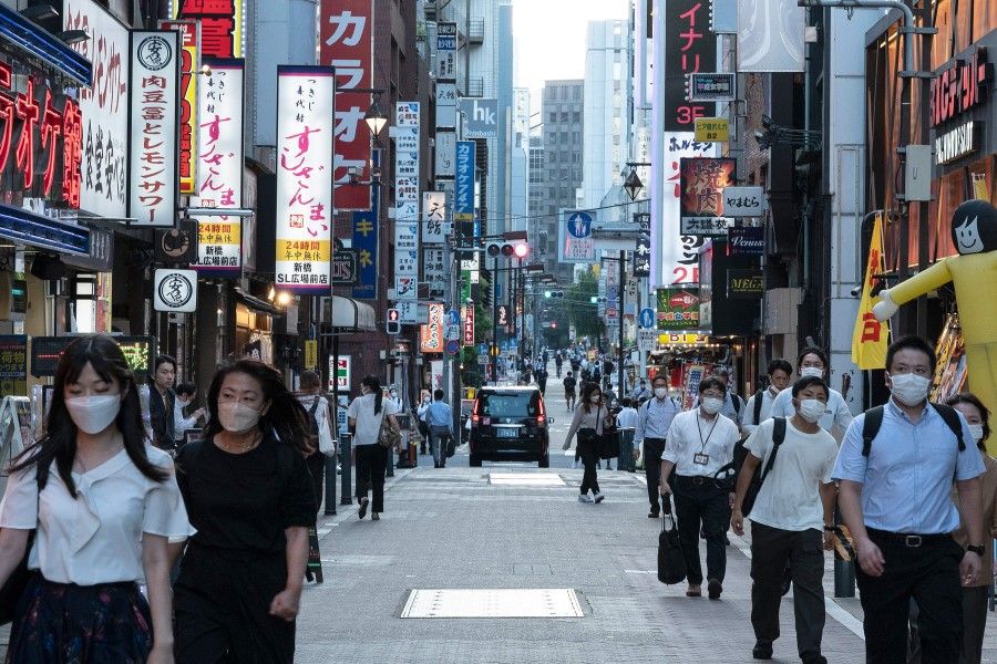 People walk down a street in the entertainment area of Shimbashi in Tokyo on 5 September 2022. (Richard A. Brooks/AFP)