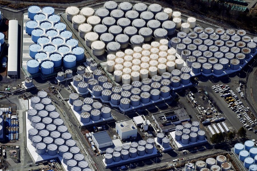 An aerial view shows the storage tanks for treated water at the tsunami-crippled Fukushima Daiichi nuclear power plant in Okuma town, Fukushima prefecture, Japan, 13 February 2021, in this photo taken by Kyodo. (Kyodo via Reuters)