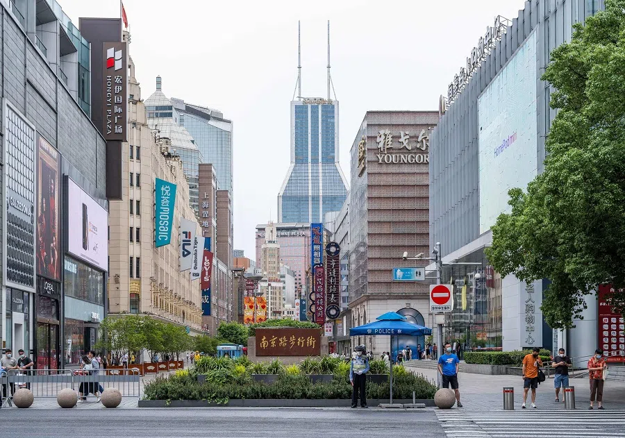 Pedestrians walk in the commercial area along Nanjing Road in Shanghai, China, on 10 June 2022. (Liu Jin/AFP)