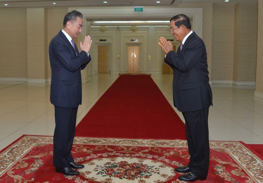 Cambodia's Prime Minister Hun Sen (right) greets China's Foreign Minister Wang Yi during a meeting at the Peace Palace in Phnom Penh on 12 October 2020. (AFP)