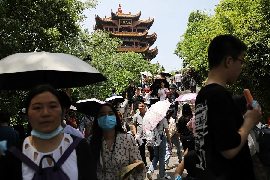 Visitors walk near the Yellow Crane Tower during the Labour Day holiday in Wuhan, Hubei province, China, 2 May 2021. (Tingshu Wang/Reuters)