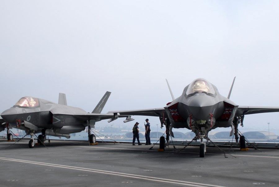 F-35B Lightning II aircraft are seen on the deck of HMS Queen Elizabeth, currently moored at the port of Limassol, Cyprus, 1 July 2021. (Yiannis Kourtoglou/Reuters)