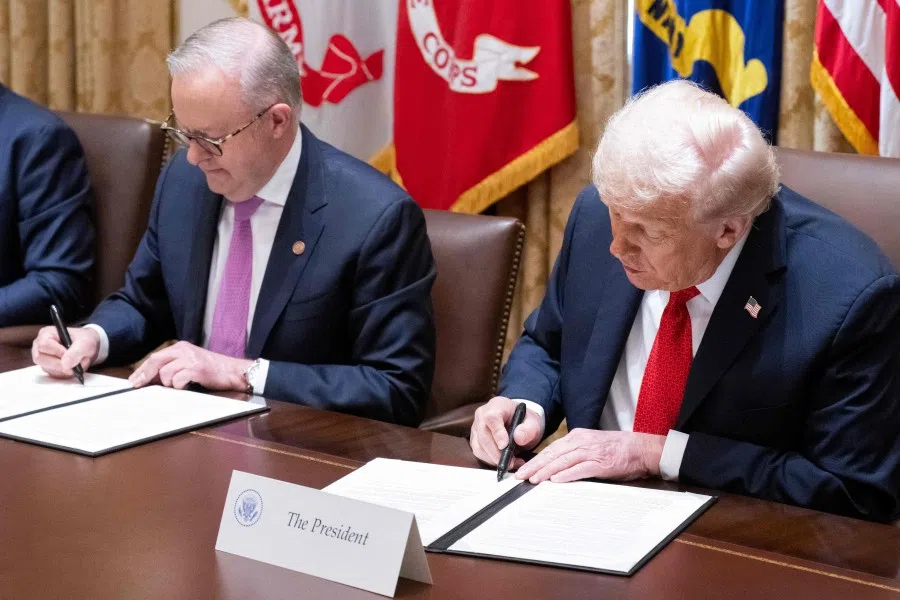 US President Donald Trump (right) and Australia’s Prime Minister Anthony Albanese sign a document on critical minerals in the Cabinet Room at the White House in Washington, DC, on 20 October 2025. (Saul Loeb/AFP)
