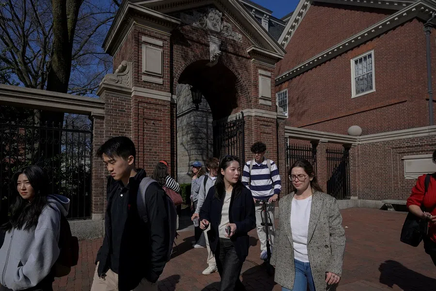 Students walk on the campus of Harvard University in Cambridge, Massachusetts, US, on 15 April 2025. (Faith Ninivaggi/Reuters)