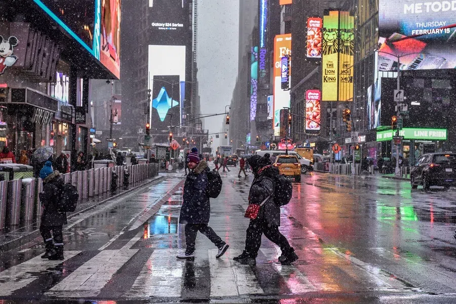 Pedestrians walk through the Times Square neighbourhood of New York, US, on 13 February 2024. (Stephanie Keith/Bloomberg)
