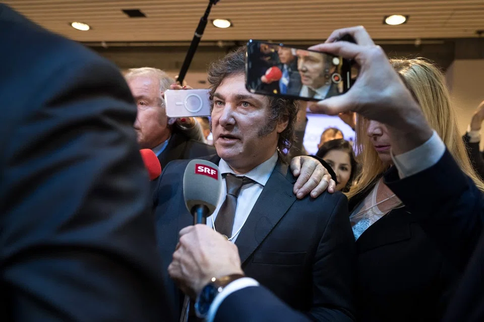 Argentina's President Javier Milei leaves surrounded by media after delivering a speech at the World Economic Forum (WEF) meeting in Davos on 17 January 2024. (Fabrice Coffrini/AFP)