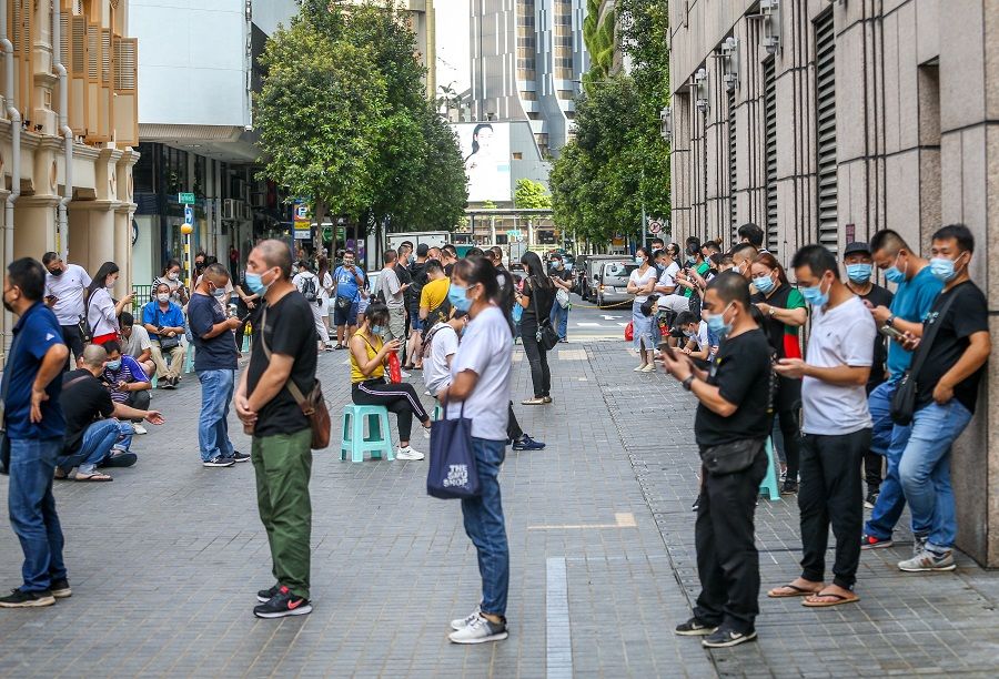 People queue up at a clinic along North Bridge Road in Singapore on 21 June 2021 to register for Sinovac vaccination. (SPH Media)