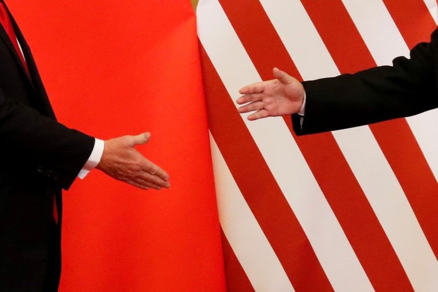 US President Donald Trump and China's President Xi Jinping shake hands after making joint statements at the Great Hall of the People in Beijing, November 2017. (Damir Sagolj/REUTERS)