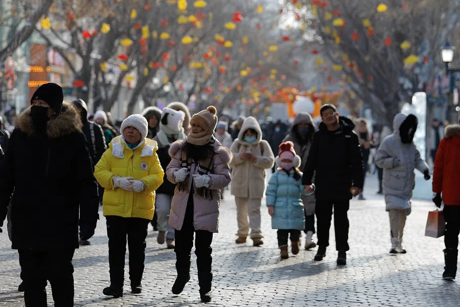 People walk on Harbin's Central Street, in Heilongjiang province, China, on 5 January 2024. (Tingshu Wang/Reuters)