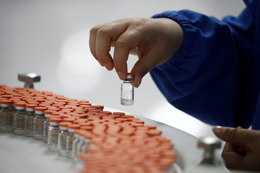 A worker in the packaging facility of Chinese vaccine maker Sinovac Biotech, developing an experimental Covid-19 vaccine, in Beijing, China, 24 September 2020. (Thomas Peter/Reuters)