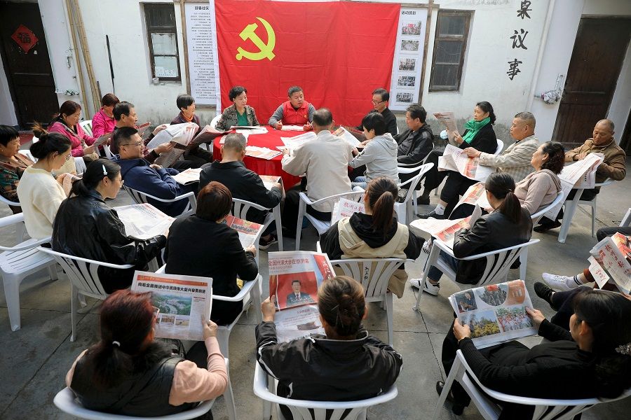 People gather to read reports of the 20th Party Congress, in Hangzhou, Zhejiang province, China, on 18 October 2022. (AFP)