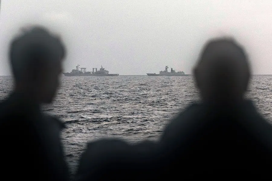 This handout photo taken on 13 February 2025 and released by The Australian Defence Force shows sailors onboard the Royal Australian Navy ship HMAS Arunta looking at the People’s Liberation Army-Navy (PLA-N) Fuchi-class replenishment vessel and Weishanhu Jiangkai-class frigate Hengyang in the Tasman Sea. Australia’s foreign minister voiced concern on 21 February over live fire drills conducted by three Chinese warships sailing off the country’s east coast.