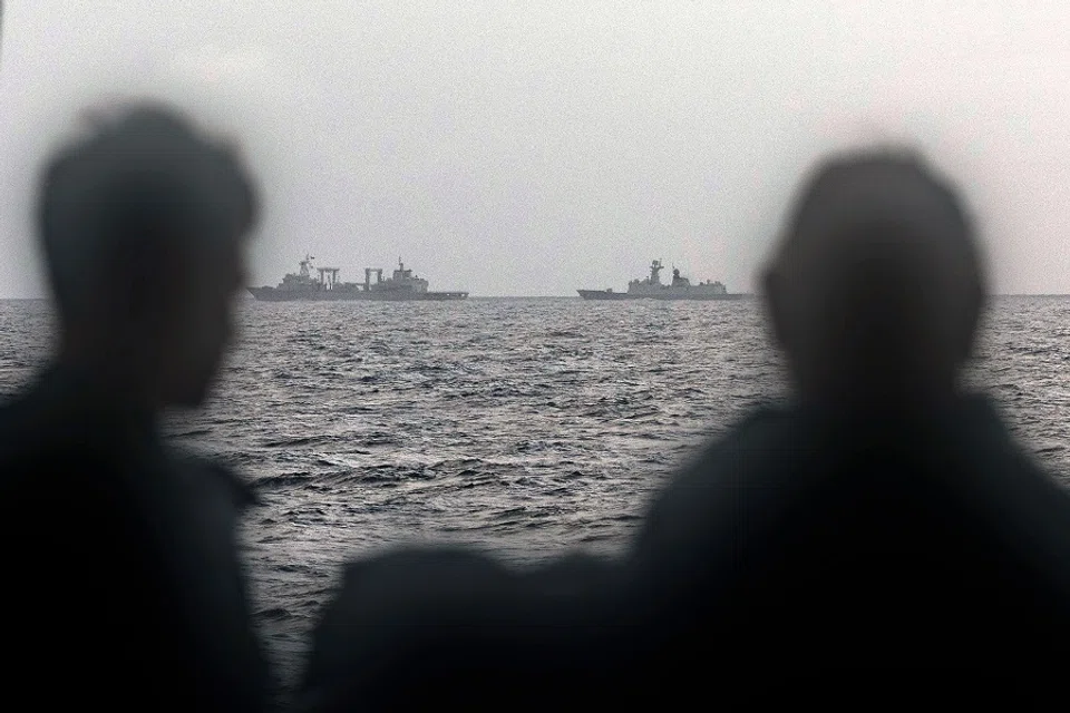 This handout photo taken on 13 February 2025 and released by The Australian Defence Force shows sailors onboard the Royal Australian Navy ship HMAS Arunta looking at the People’s Liberation Army-Navy (PLA-N) Fuchi-class replenishment vessel and Weishanhu Jiangkai-class frigate Hengyang in the Tasman Sea. Australia’s foreign minister voiced concern on 21 February over live fire drills conducted by three Chinese warships sailing off the country’s east coast. (Australian Defence Force/AFP)