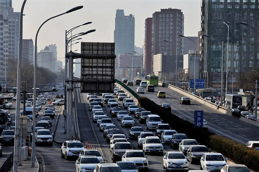 Cars move on a street in Beijing's central business district during morning rush hour in Beijing, China, 30 January 2023. (Tingshu Wang/File Photo/Reuters)