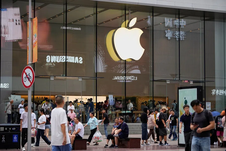 People walk past an Apple store in Shanghai, China, on 13 September 2023. (Aly Song/Reuters)