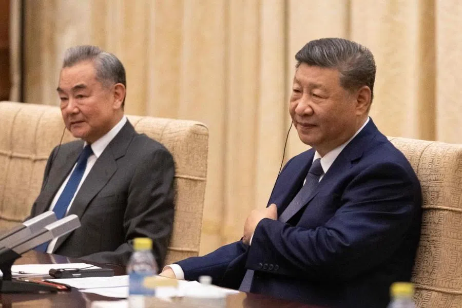 Chinese President Xi Jinping (right) and Foreign Minister Wang Yi (left) at a meeting with German Chancellor Friedrich Merz (not pictured) at the Diaoyutai State Guesthouse in Beijing on 25 February 2026. (Jessica Lee/AFP)