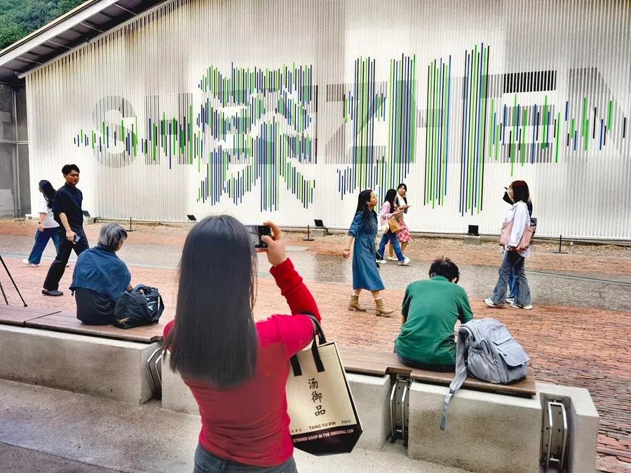 People take photos of a wall in Shenzhen, China, with the name of the city depicted in Mandarin on 12 November 2025.