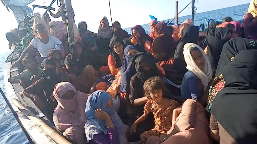A boat carrying Rohingya refugees, including women and children, is seen stranded in waters off the coast of Bireuen, Aceh province, Indonesia, in this still image taken from a video recorded on 27 December 2021. (Aditya Setiawan via Reuters)
