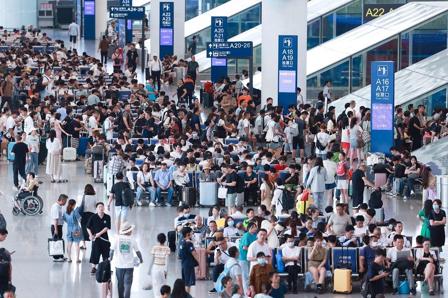 Passengers wait for their trains at a railway station in Chengdu, Sichuan province, China, on 29 June 2023. (AFP)