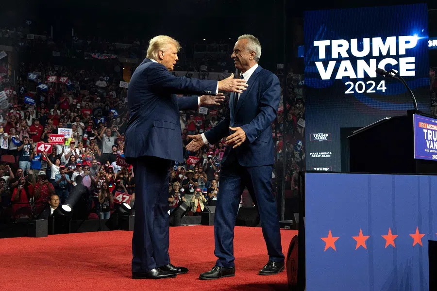 Republican presidential nominee and former US President Donald Trump (left) embraces former presidential candidate Robert F. Kennedy Jr. during a campaign rally at Desert Diamond Arena on 23 August 2024 in Glendale, Arizona, US.