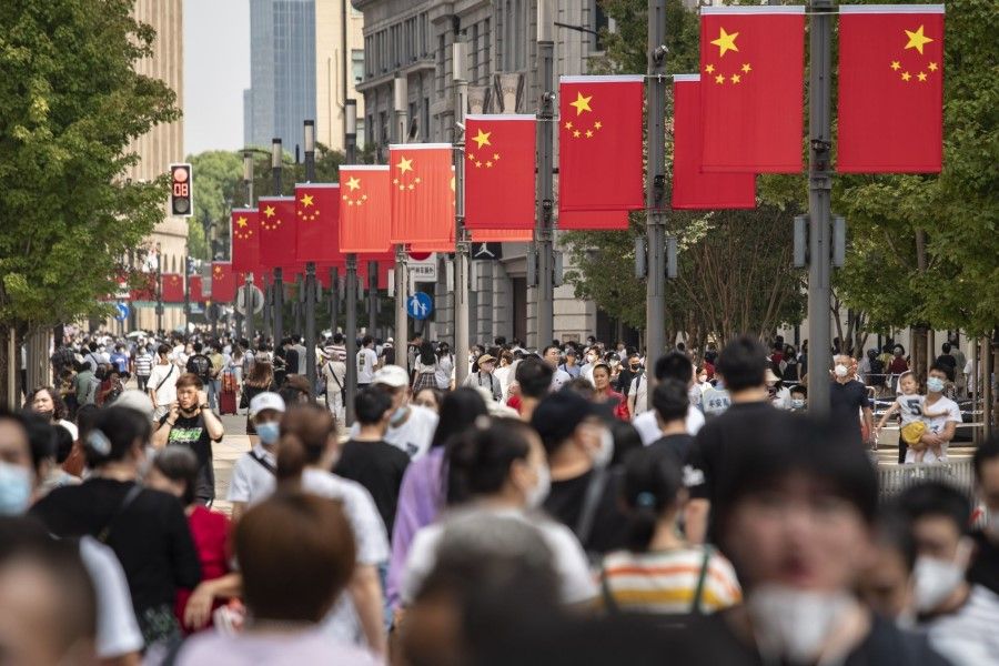 Visitors walk down Nanjing Road in Shanghai, China, on 2 October 2022. (Qilai Shen/Bloomberg)