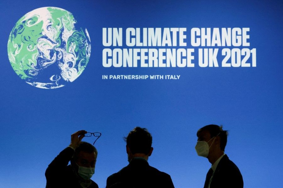 People are silhouetted during the UN Climate Change Conference (COP26), in Glasgow, Scotland, Britain, 10 November 2021. (Yves Herman/Reuters)