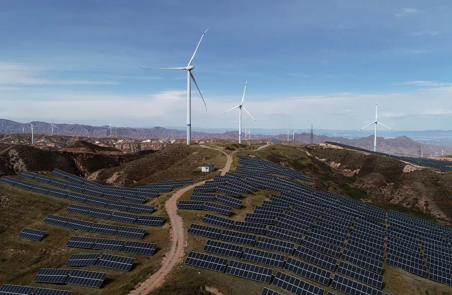 Wind turbines and solar panels are seen at a wind and solar power plant by State Power Investment Corporation in Zhangjiakou, Hebei province, China, on 29 October 2018.