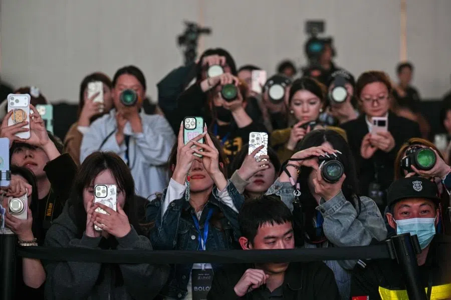 This picture taken on 13 November 2025 shows fans, influencers and media personnel attending the presentation of Rokid glasses in Hangzhou, in China’s eastern Zhejiang province. (Hector Retamal/AFP)