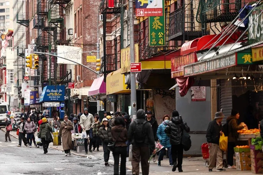 People move along a street of Chinatown in the Manhattan borough of New York City on 6 March 2026.