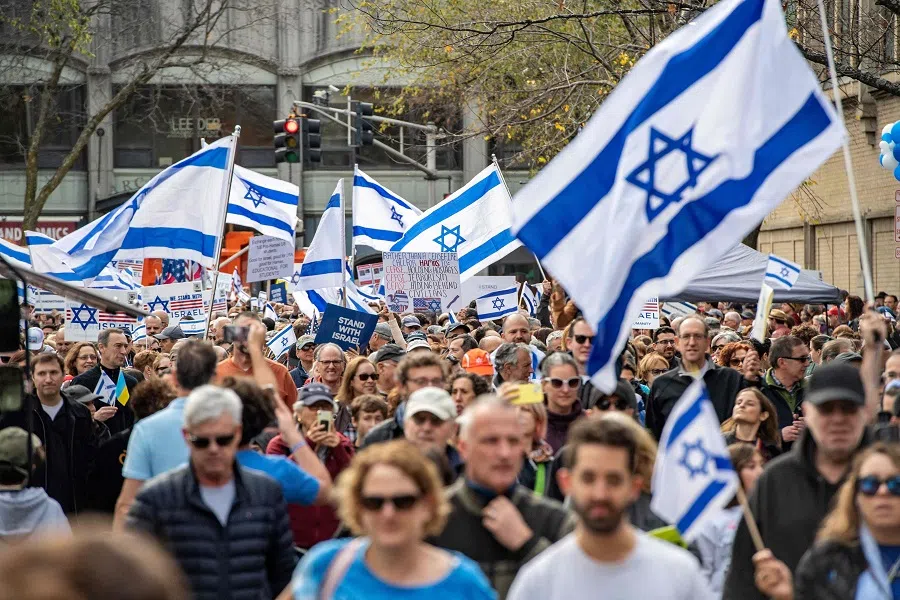 People march during a rally to show local support for Israel's right to exist and defend itself in the war against Hamas in Brookline, Massachusetts, US, on 5 November 2023. (Joseph Prezioso/AFP)