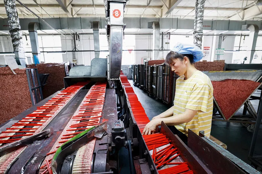 An employee works on a pencil production line at a factory in Sihong, in eastern China’s Jiangsu province on 24 July 2024. (AFP)