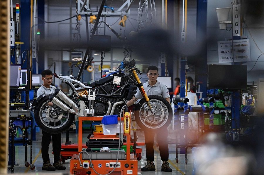 In this picture taken on 30 August 2023, workers assemble a motorbike at the Northstar Precision Vietnam factory in Vinh Phuc province. (Nhac Nguyen/AFP)