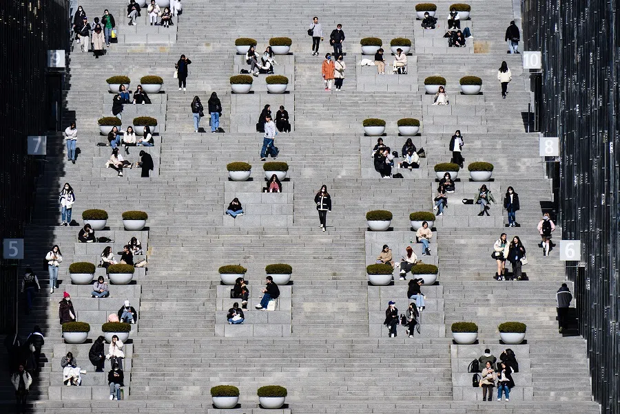 Students and visitors walk around the campus of Ewha Womans University in Seoul on 2 March 2023, which was founded in 1886.