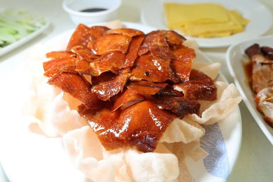Local Cantonese-style Peking duck is typically served with the skin attached to the meat, and eaten wrapped in egg crepes. (Neoh Kee Leng/SPH Media)