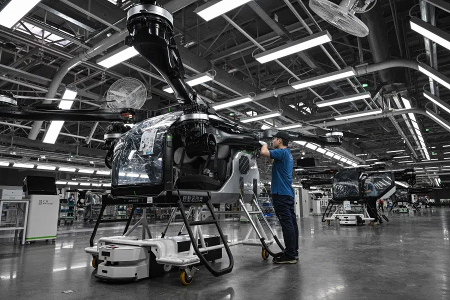 Employees work on the assembly line for the electric flying car “Land Aircraft Carrier” at a factory of Xpeng’s subsidiary Aridge in Guangzhou, in southern China’s Guangdong province on 6 November 2025. (Jade Gao/AFP)