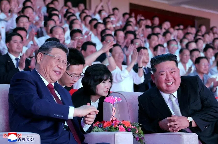 Chinese President Xi Jinping sits next to North Korean leader Kim Jong Un as he attends a performance at the Pyongyang Indoor Stadium, during his state visit, in Pyongyang, North Korea, on 8 June 2026, in this picture released by North Korea's official Korean Central News Agency.