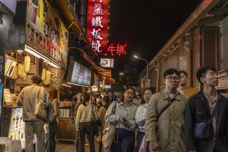 Pedestrians walk through the Shi Lin Night Market in Taipei, Taiwan, on 5 December 2023. (Lam Yik Fei/Bloomberg)