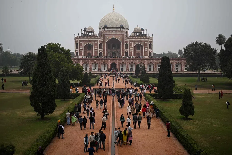Visitors walk in front of the Humayun’s Tomb, a 16th century Mughal monument, in New Delhi on 29 December 2024. (Sajjad Hussain/AFP)