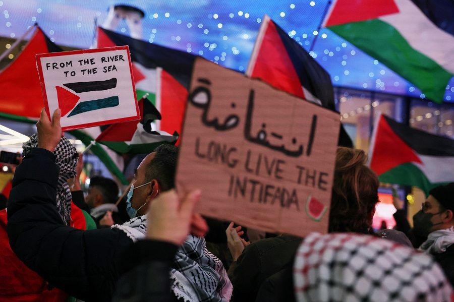 Pro-Palestinian demonstrators walk along 7th avenue, amid the ongoing conflict between Israel and Hamas, outside of Pennsylvania Station in New York City, US, on 18 December 2023. (Shannon Stapleton/Reuters)