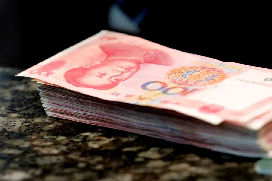 Chinese 100 RMB banknotes are seen on a counter of a branch of a commercial bank in Beijing, China, 30 March 2016. (Kim Kyung-Hoon/Reuters)