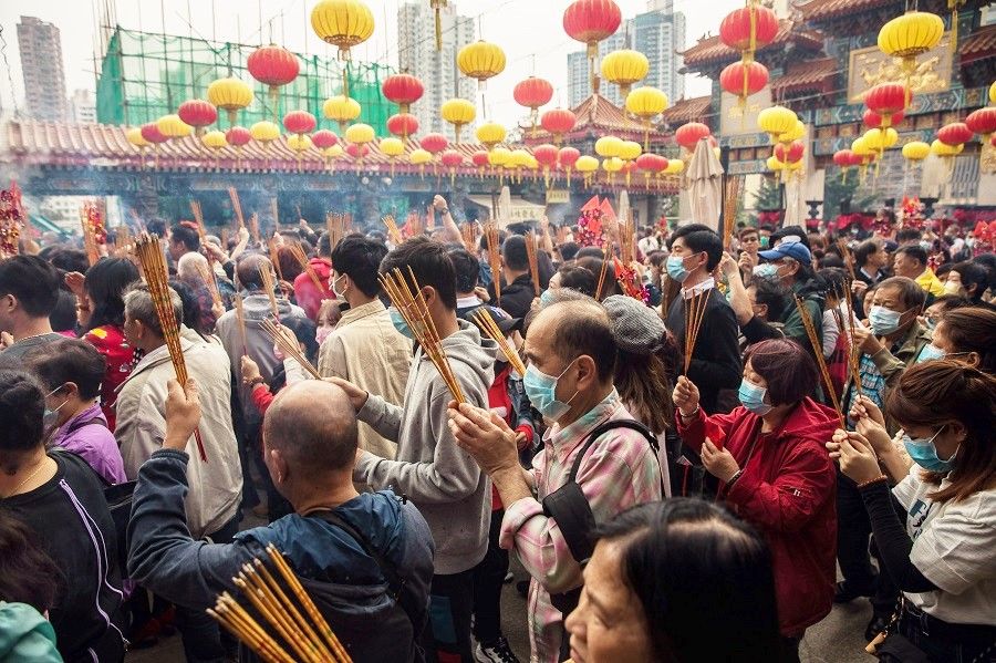 Seeking spirituality is a universal human need. In this photo taken on 25 January 2020, people wearing face masks visit Wong Tai Sin temple on the first day of the Lunar New Year of the Rat in Hong Kong, as a preventative measure against the Covid-19 coronavirus. (Dale De La Rey/AFP)