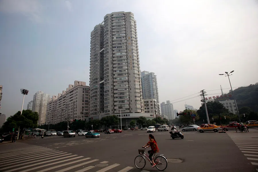A woman rides a bicycle through an intersection in Wenzhou, Zhejiang Province, China, on 24 October 2011. (Qilai Shen/Bloomberg)