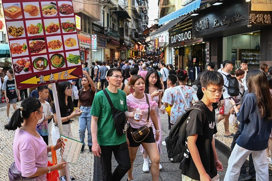 This photo taken on 3 October 2023 shows Chinese tourists visiting Macau during the country's week-long holiday at the start of October. (Peter Parks/AFP)